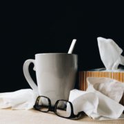 cup of tea, tissues, glasses on a table top